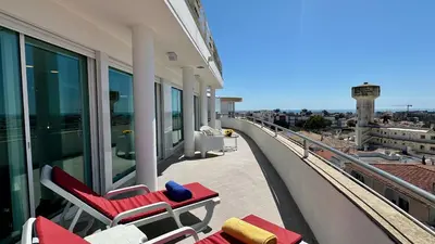 a balcony with lounge chairs on a building at Ocean Drive by Check-in Portugal in Albufeira