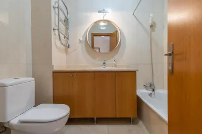 a bathroom with a toilet and a sink and a mirror at Vilamoura Residence in Quarteira