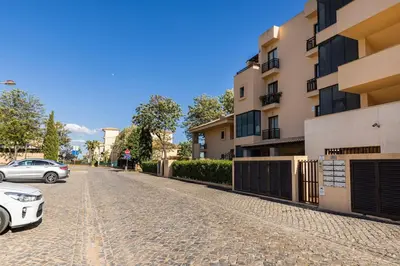 a cobblestone street in front of a building at Vilamoura Residence in Quarteira