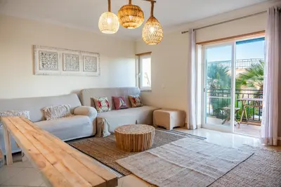 a living room with a couch and a table at Old Town Boho Seaview Elegance in Albufeira