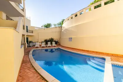 a swimming pool on the side of a building at Old Town Boho Seaview Elegance in Albufeira