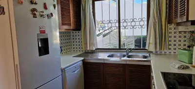 a small kitchen with a sink and a window at Sao Rafael Village 2 Bedroom with a Pool in Albufeira