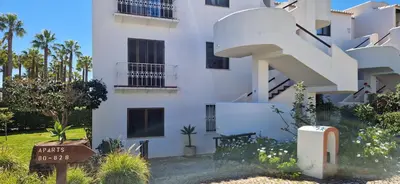 a white building with a sign in front of it at Sao Rafael Village 2 Bedroom with a Pool in Albufeira
