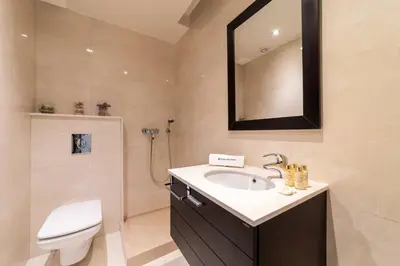 a bathroom with a sink and a toilet and a mirror at Villa Colina - A1 by HelloVacations in Albufeira