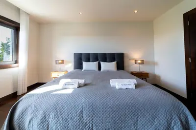 a bedroom with a large bed with two towels on it at Villa Colina - A1 by HelloVacations in Albufeira
