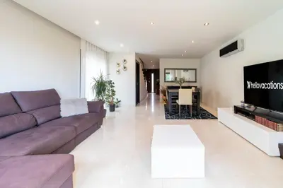 a living room with a couch and a tv at Villa Colina - A1 by HelloVacations in Albufeira