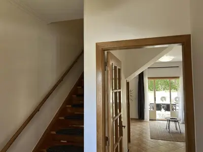 a hallway with a stairway and a door to a house at Moradia B - 200m da Praia da Oura - Leste in Albufeira