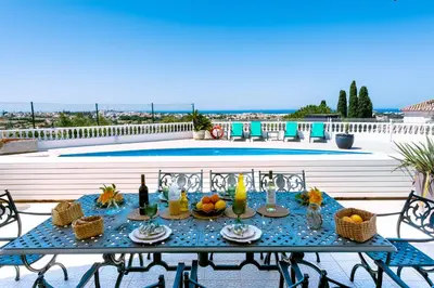 a table with fruit and wine bottles on a patio at Casa Sonhos in Albufeira