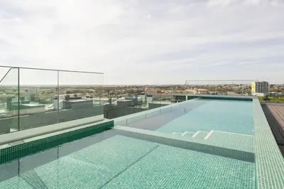 a swimming pool on the roof of a building at TAC - Alma Apartment in Faro