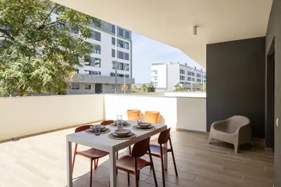 a dining room with a table and chairs on a balcony at TAC - Alma Apartment in Faro