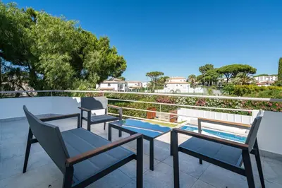 three chairs and a table on a balcony at Villa Celeste by SAPvillas in Vilamoura