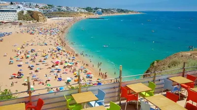 a beach with a crowd of people and the ocean at Brand New Studio in Rua da Oura in Albufeira