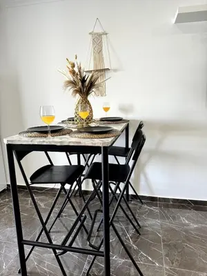 a dining room table with two glasses of wine at Brand New Studio in Rua da Oura in Albufeira