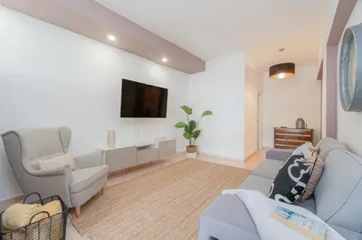 a living room with a couch and a tv at Central Apartment by Ocvillas in Albufeira