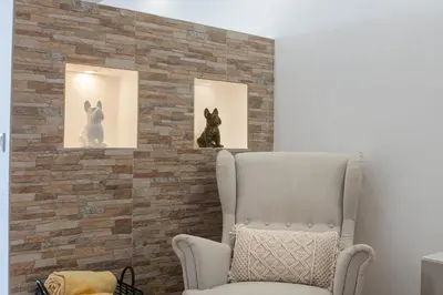 a living room with a couch and a clock on the wall at Central Apartment by Ocvillas in Albufeira