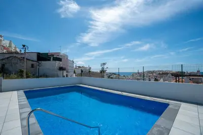 a swimming pool on the roof of a house at Central Apartment by Ocvillas in Albufeira