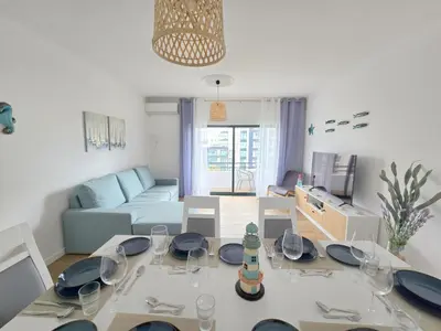 a bedroom with two beds with blue pillows at Modern Beach Apartment - Avenida Mar 2 - 150 mts da praia in Quarteira