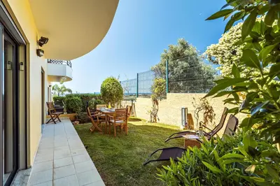 a patio with chairs and a table in a yard at Albufeira Vista Marina Apt - Old Town in Albufeira