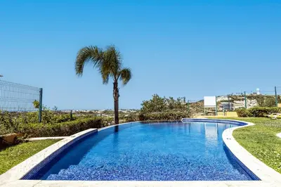a swimming pool with a palm tree in a yard at Albufeira Vista Marina Apt - Old Town in Albufeira