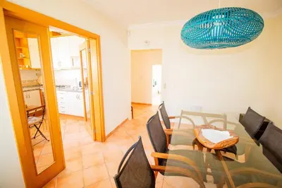 a dining room with a table and chairs at Vila Anna in Albufeira