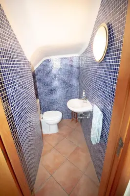 a bathroom with a toilet and a sink at Vila Anna in Albufeira