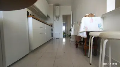 a bathroom with a white toilet and a sink at Quarteira First Line Front Beach Pool Flat View in Quarteira