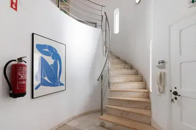 a staircase with a fire extinguisher on the wall at Villa Rebelo in Albufeira