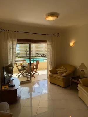 a living room with a couch and a table at Galé Mar By Albufeira Rental in Albufeira