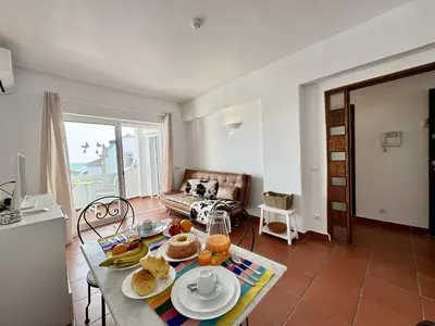 a table and chairs on a balcony with a view at Albufeira Ocean View III by Homing in Albufeira