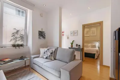 a small kitchen with a white table and chairs at Casa Viola in Faro