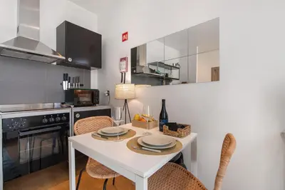 a kitchen with a table with plates on it at Casa Viola in Faro