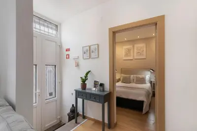a bedroom with a bed and a mirror at Casa Viola in Faro