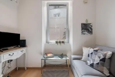 a living room with a couch and a window at Casa Viola in Faro