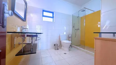 a bathroom with a toilet and a glass shower at Casa das ficus in Guia