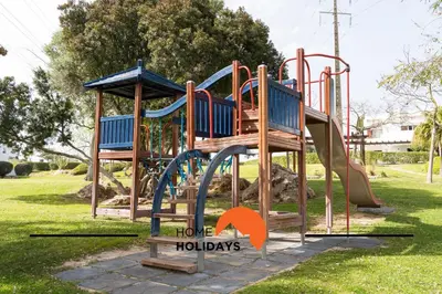 a playground with a slide in a park at #293 Clube Albufeira 309 by Home Holidays in Albufeira