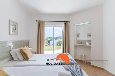 a bedroom with a large bed with a window at #293 Clube Albufeira 309 by Home Holidays in Albufeira