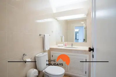 a bathroom with a toilet and a sink and a mirror at #293 Clube Albufeira 309 by Home Holidays in Albufeira