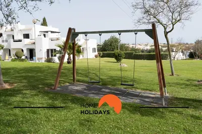 a swing set in the yard of a house at #293 Clube Albufeira 309 by Home Holidays in Albufeira