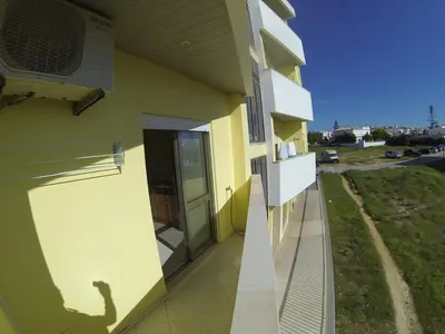 a building with a shadow of a person on the side of it at T2 Faro in Faro