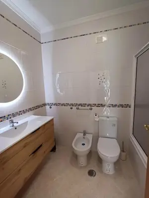 a bathroom with a toilet and a sink at T2 Faro in Faro