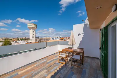 a balcony with a table and chairs and a water tower at Azinhais Apartment - Heart of Oura in Albufeira