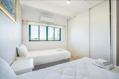 a bedroom with two beds and a window at Azinhais Apartment - Heart of Oura in Albufeira