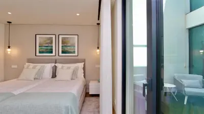 a bedroom with a white bed and a lamp at Villa Essence by Clever Details, private pool, central location in Vilamoura