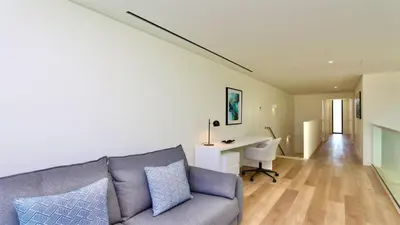 a living room with a fireplace and a large window at Villa Essence by Clever Details, private pool, central location in Vilamoura