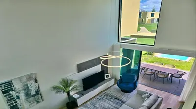 a bedroom with a bed with blue and white pillows at Villa Essence by Clever Details, private pool, central location in Vilamoura