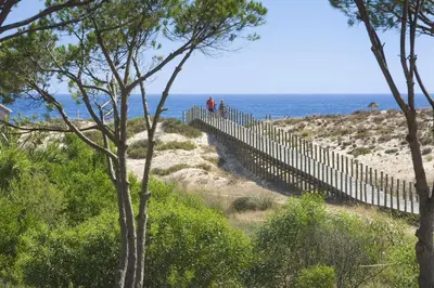 two people walking along a fence on the beach at Sunny Lounge Apartment in Vale do Lobo