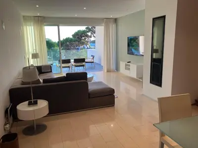 a living room with a couch and a table at Sunny Lounge Apartment in Vale do Lobo