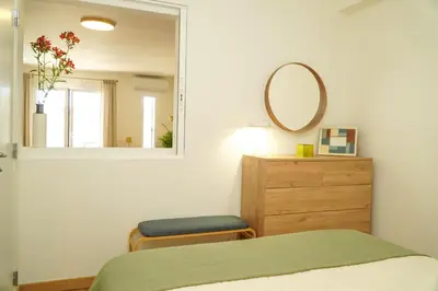 a bedroom with a bed and a mirror and a dresser at Stanchion Apartment in Albufeira