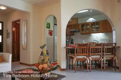 a kitchen with an archway in a living room at Akivillas Quarteira Relax in Quarteira