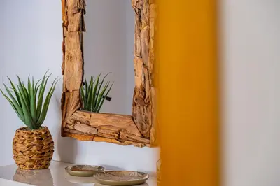 a mirror on a wall with a pineapple on a table at Vale Parra Village By Cabritatur in Guia